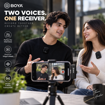 Lifestyle image showing two creators using the dual wireless microphones with a smartphone recording setup.
